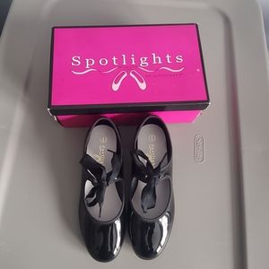 Spotlights girls tie tap shoes.